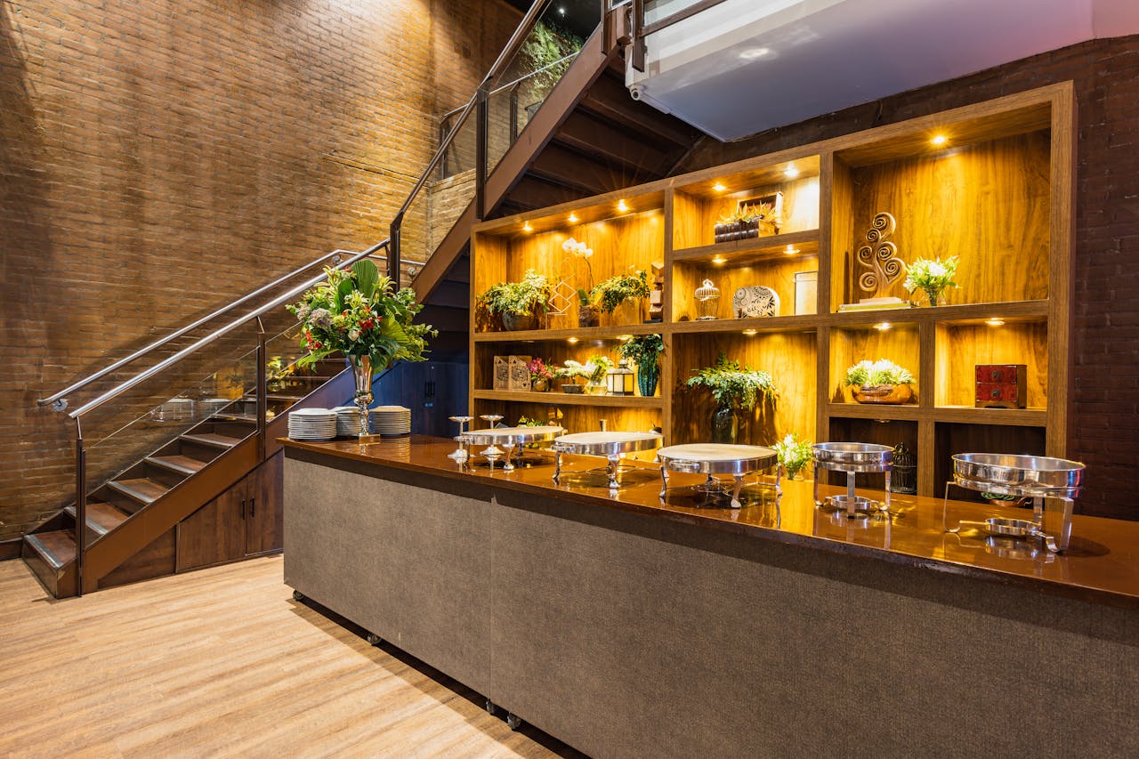 Stylish buffet area in a luxury restaurant interior with warm lighting and floral decorations.