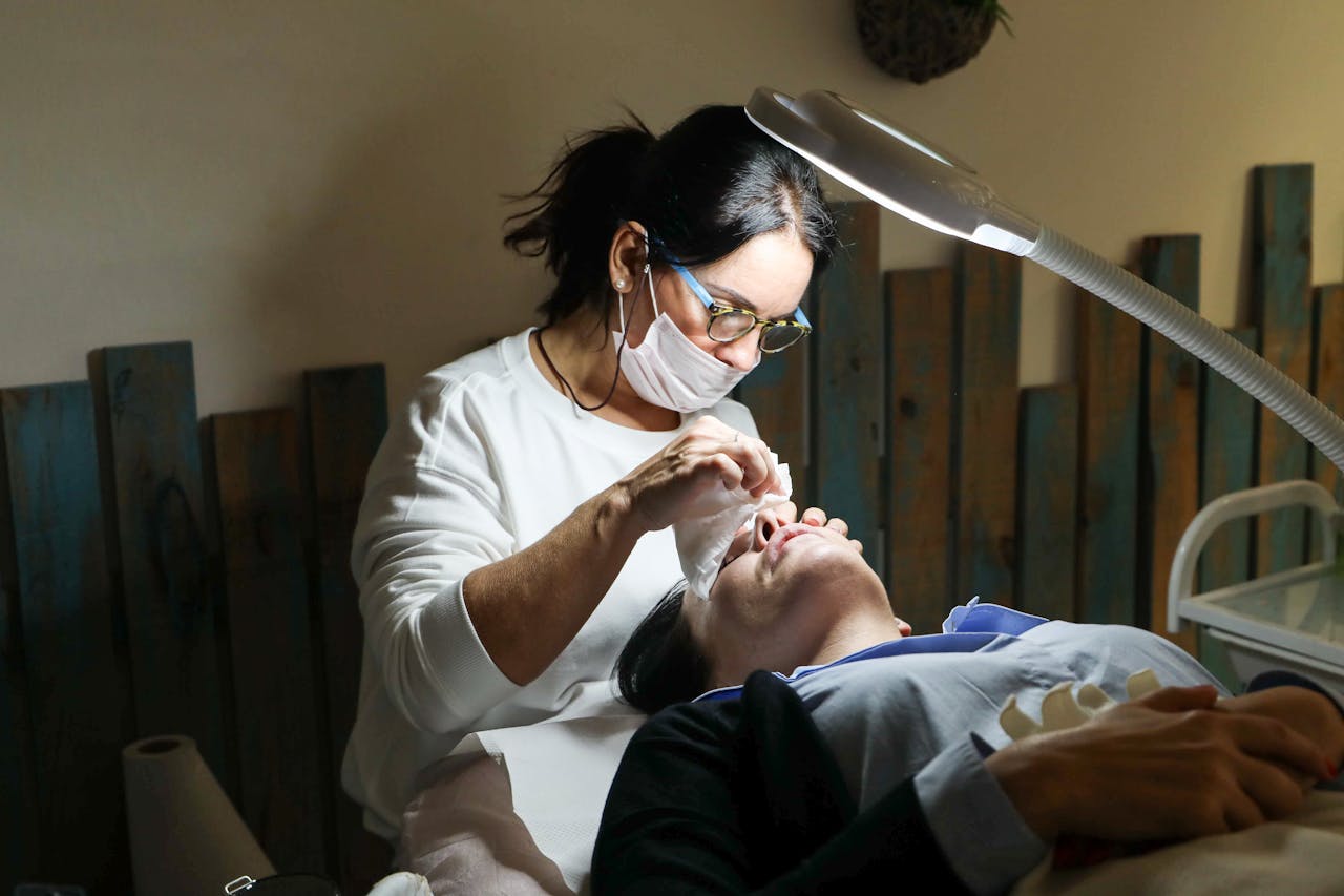 Esthetician provides a detailed facial treatment to a client in a spa setting.